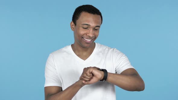 Young African Man Using Smartwatch