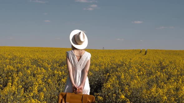 woman in white dress with suitcase and binocular