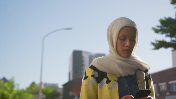 Young woman wearing hijab out and about in the city