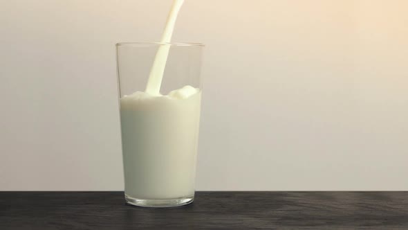 Pouring A Glass Of Milk In The Kitchen