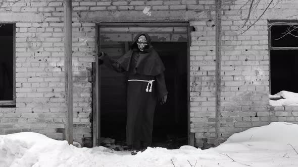 Grim Reaper Waving Hand By a Abandoned Building