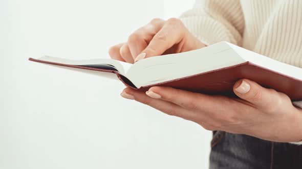 Close Up of Female Hands Turning Pages of a Book