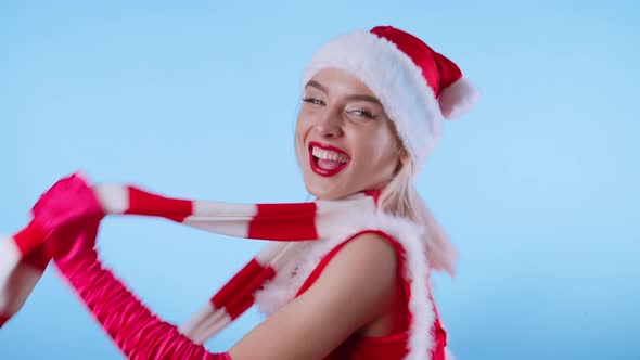 Cute Young Woman in Santa Claus Costume Dancing