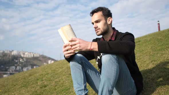 Man Perusing Book Outside