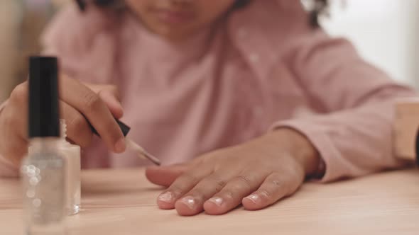 Unrecognizable Child Painting Nails with Polish