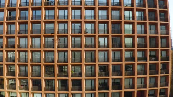 Grid of Window Patio's on Residential Skyscraper Building - Aerial Rising