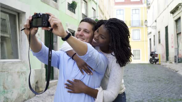 Cheerful Mix Raced Tourist Couple Taking Selfie