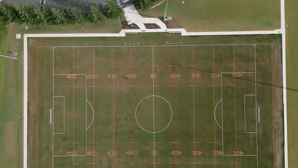 Aerial top down flying over a football, soccer, rugby field