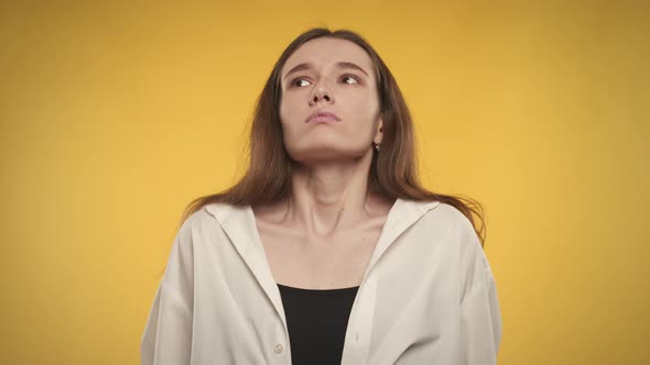 Woman Taking a Deep Breath and Exhale on a Bright Yellow Background