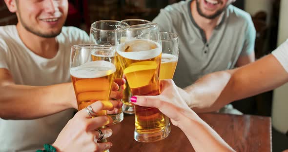 Smiling Carefree Friends Enjoying Drinking Together in Bar Group of Happy Young Men Drinking Cold