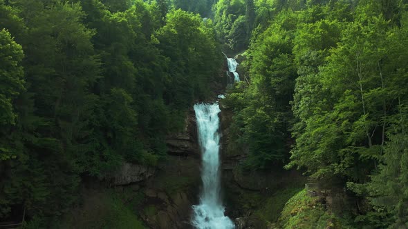 Beautiful waterfall in alpine forest, Giessbachfall Switzerland, aerial