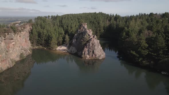 The Disused Carrigfoyle Quarry In Barntown, County Wexford With Lake Surrounded By Forest And Toweri