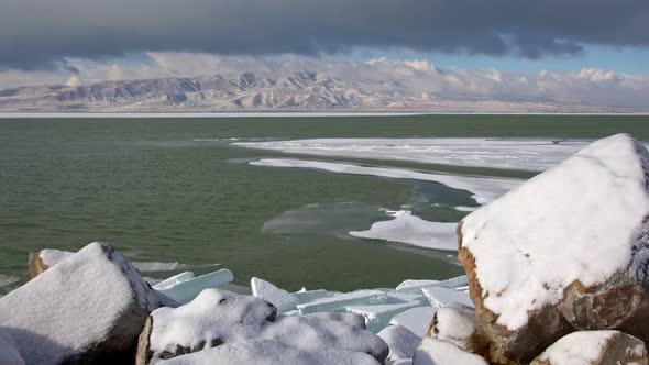 Utah Lake in winter as wind is blowing with ice on the water