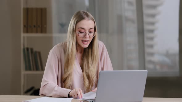 Angry Businesswoman Blonde Girl with Glasses in Office Angry Conversation Remote Quarrel Video Call