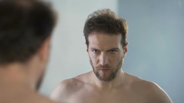 Man Looking at His Mirror Reflection With Hatred and Shame, Feeling Guilty