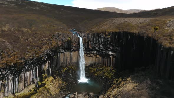 Aerial View of the Svartifoss Waterfall Surrounded By Basalt Columns in Iceland