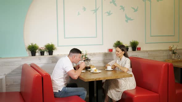 Lovely Couple Drinks Tea Having Date in Confectionery Shop