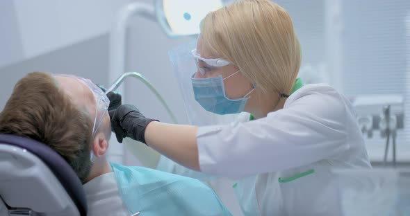 Dental Treatment in a Modern Dental Clinic. Dentist Drills a Tooth To a Patient, Caries Treatment