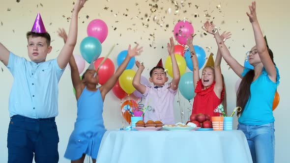 Children Throw Shiny Confetti Celebrating Birthday at Table