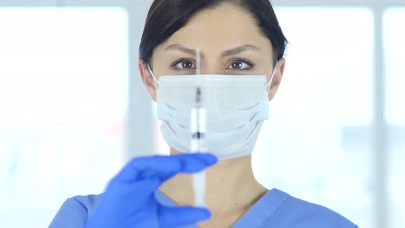 Doctor in Mask Holding Injection, Ready to inject