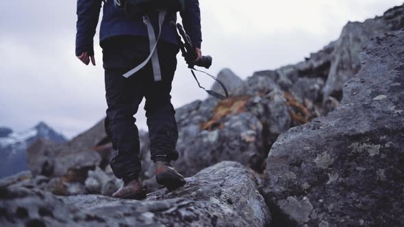 Hiker Stepping Over Rocks Camera