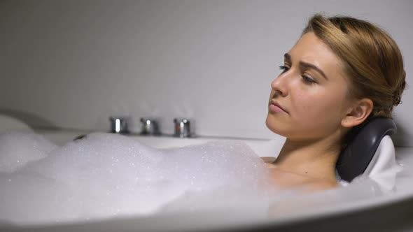 Upset Woman Lying in Bath With Foam Bubbles, Relieving Stress, Life Problems