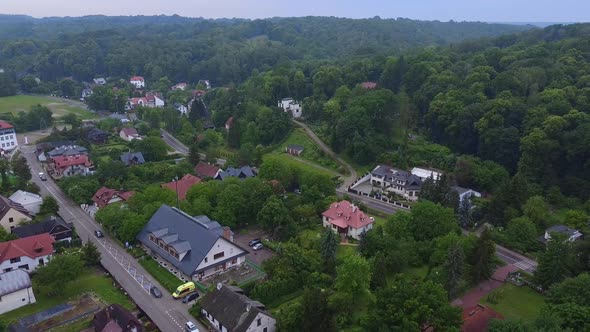 Aerial Footage of City Buildings and Green Forest