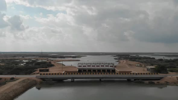 Aerial Over Bridge And Barrage Gate In Sindh Pakistan With Clouds Overhead