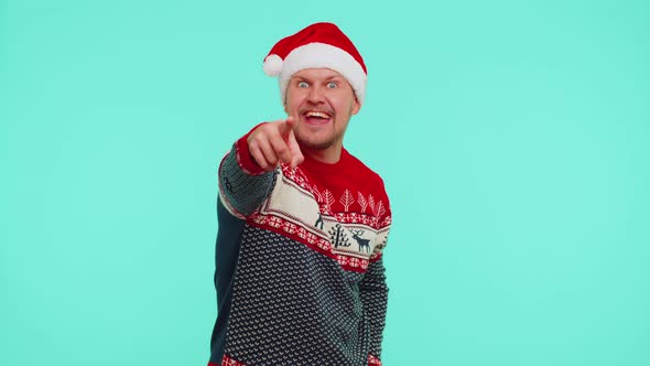 Man in Red Christmas Sweater Smiling Excitedly Pointing to Camera Beauty Choosing Lucky Winner