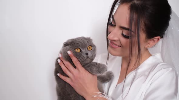 Beautiful Bride with a Cat in Her Arms