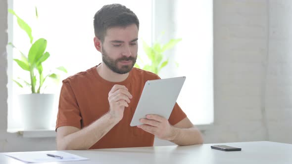 Young Man Using Tablet in Office