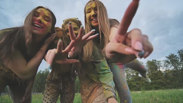 Cheerful Girls are Posing Smeared in Multicolored Powder