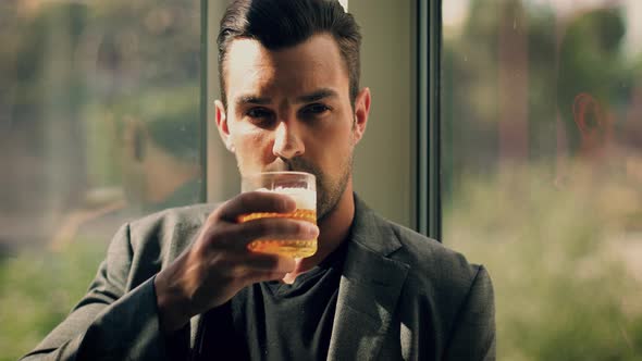 Handsome man having a drink