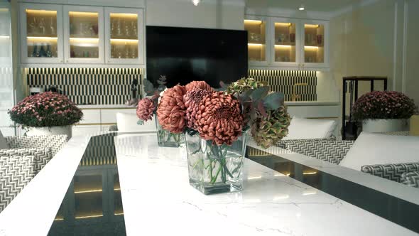 Beautiful bouquet of flowers in a vase on a marble table of a stylish luxury kitchen