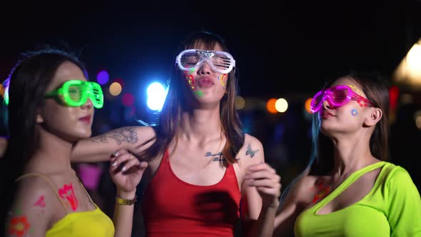 4K Group of Asian woman dancing together at full moon night party at tropical island beach.