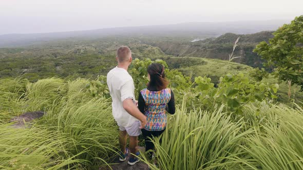 Happy Couple Hugging on Green Mountain Peak and Enjoying Beautiful Landscape. Man and Woman