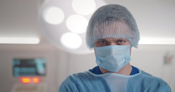 Portrait of Male Surgical Nurse in Sterile Uniform Standing in Operating Theatre