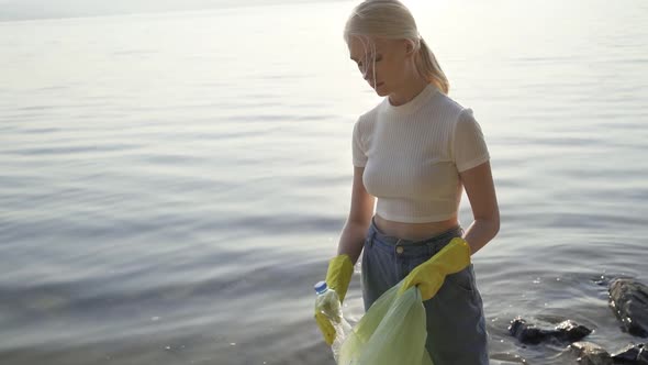 Portrait of Young Lady Volunteers Help to Keep Nature Clean Up Looking at Camera with Garbage Bags