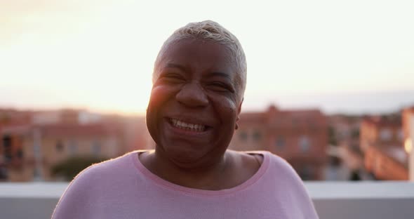 Happy african mature woman looking and smiling in camera