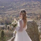 Pretty Young Bride Wearing Long White Dress Walking Against Mountains View - VideoHive Item for Sale