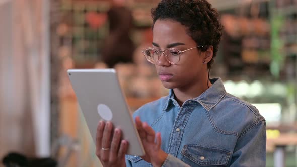 Portrait of Serious African Woman Using Digital Tablet