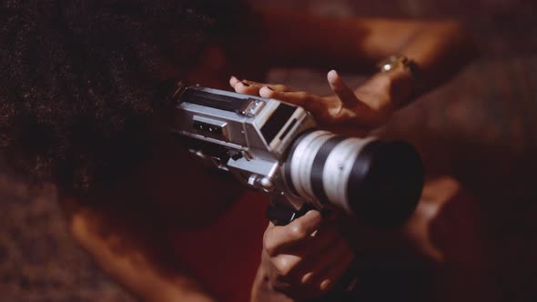 Woman With Afro Hair Filming With Vintage 8Mm Camera