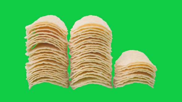 Stop motion animation stack potato chips on chroma key green screen background. alt