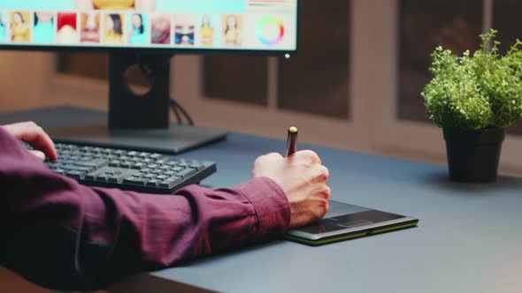 Close Up of Photographer Using Graphic Tablet to Retouch Photos