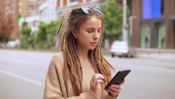 Hipster Girl Messaging on Mobile Outdoors