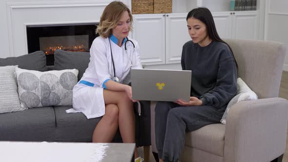 Female Doctor Showing to Patient Medical Test Results on Laptop and Prescribing Medicine