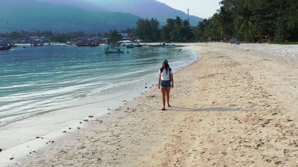 Beautiful ladies relaxing on beautiful bay beach holiday by blue green sea and white sandy backgroun