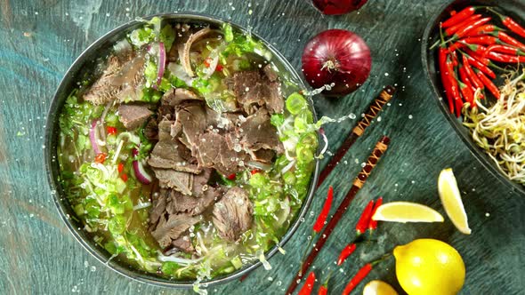 Super Slow Motion Shot of Sliced Beef Falling Into Pho Soup at 1000 Fps