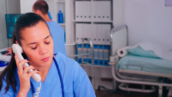 Healthcare Physician Answering Telephone in Hospital Reception