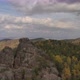 Aerial View of a Group of Tourists on Top of a High Cliff in the Autumn Forest, Free Solo Climbing - VideoHive Item for Sale